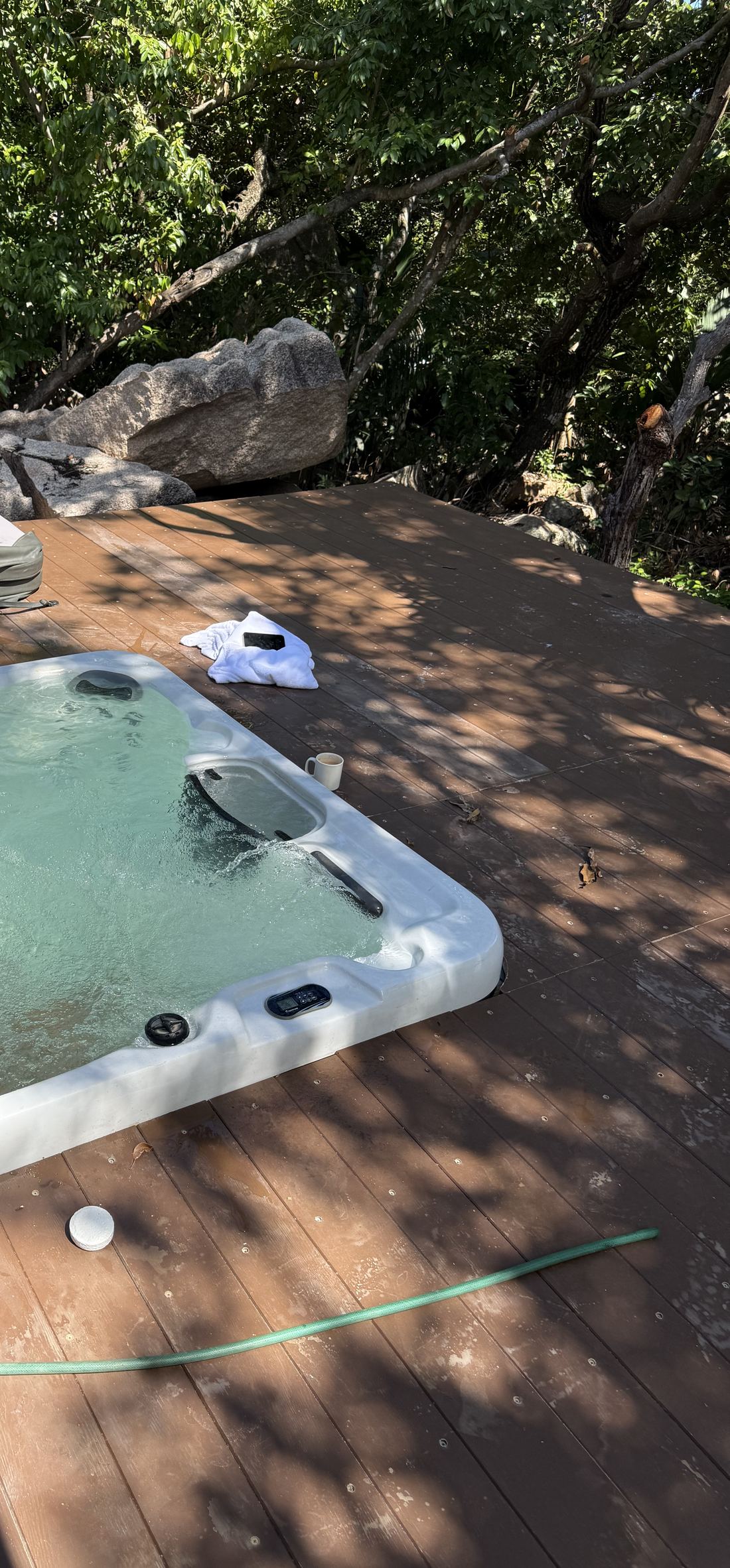 The jacuzzi on the deck, set among granite boulders and trees